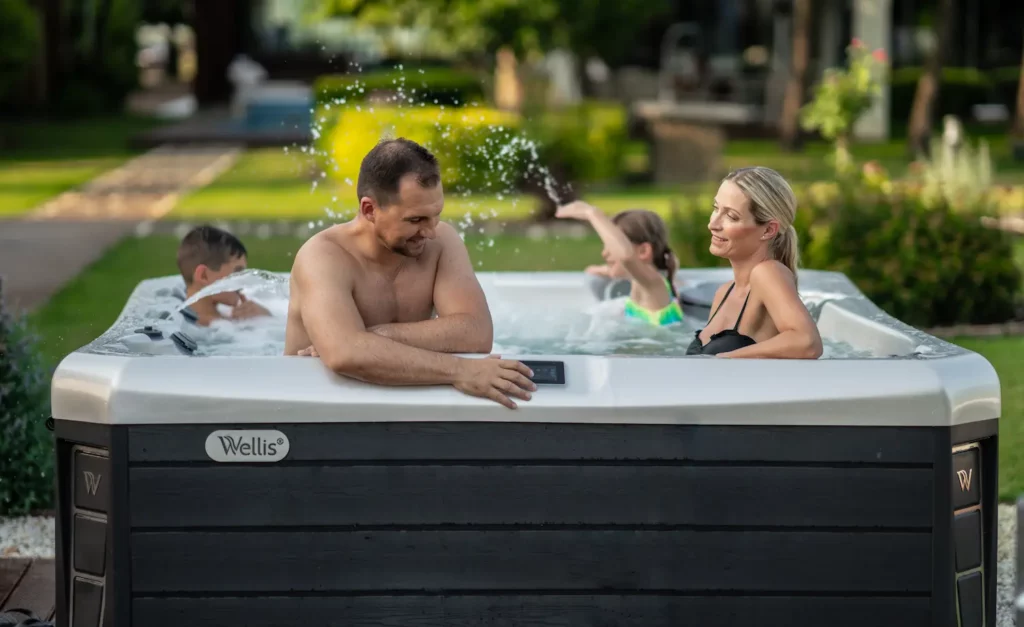 Picture of a family in their new Wellis hot tub after visiting a local hot tub store.